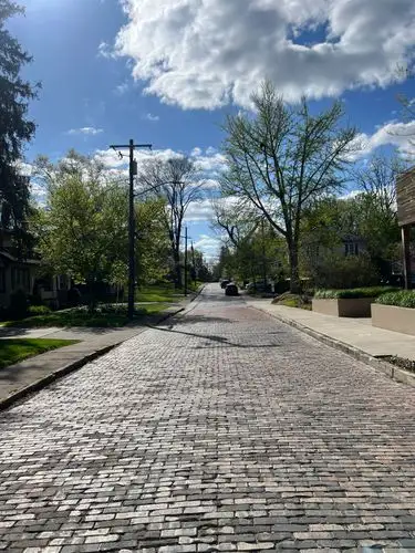 Chasing sunlight down a classic brick road.